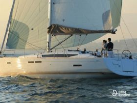 A couple enjoys a romantic sailing experience on a yacht during sunset, creating the perfect backdrop for unforgettable moments on the water.