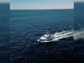 Aerial view of a speedboat cruising through deep blue waters, showcasing its sleek design and powerful movement.
