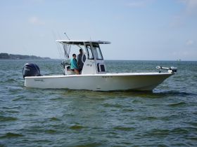 A couple enjoys a day of fishing on a sleek boat, showcasing the perfect blend of adventure and relaxation on the water.
