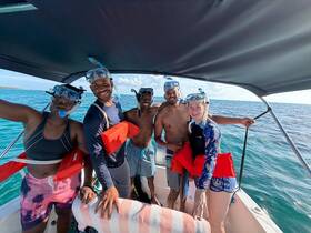 A lively group prepares for snorkeling on a boat, showcasing the excitement of underwater adventures in beautiful waters.