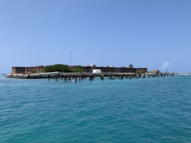 A stunning view of a historic landmark surrounded by turquoise waters, perfect for exploring the beauty of the coastline.