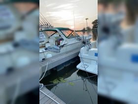 A serene view of fishing boats docked at sunset, showcasing the tranquil atmosphere of a marina.