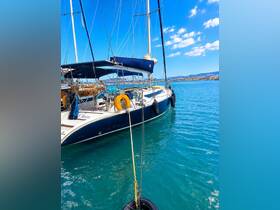 A beautiful sailboat named 'Olivia' docked in clear blue waters, showcasing its elegant design against a vibrant sky.