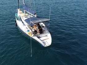 Aerial view of a sailing boat with guests enjoying their time onboard, showcasing the perfect setting for a day on the water.