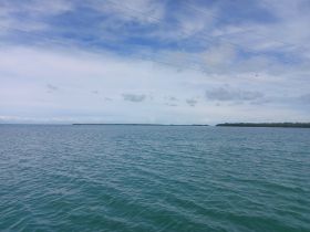 A scenic view of calm waters and a cloudy sky, but the image lacks clarity and detail.