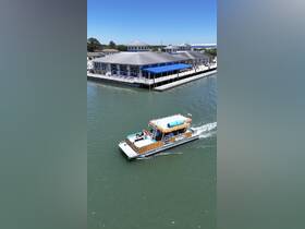 A tiki boat cruises along the waterway, providing a fun and relaxing experience for guests. Perfect for enjoying the sun and scenery while on the water.