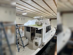 Interior view of a boat's helm and cabin area, showcasing the layout and features in a well-maintained space.