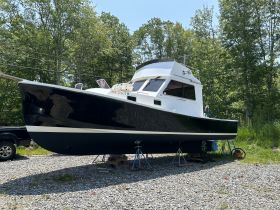 A striking side view of a boat on display, showcasing its sleek design and structure, perfect for enthusiasts and potential buyers.