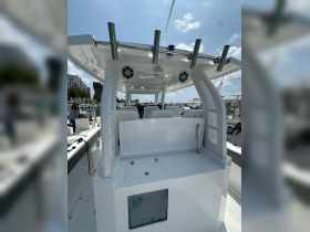 A clean and modern helm area of a boat featuring seating and storage, ideal for comfortable navigation and relaxation on the water.