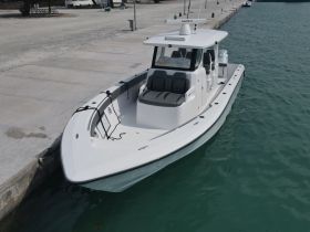 A sleek speedboat docked at the marina, showcasing its modern design and spacious seating, perfect for thrilling adventures on the water.