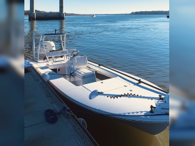 A sleek speedboat docked at the marina, showcasing its modern design and ready for a day on the water.