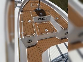 Detailed view of the interior deck of a Sea Chaser boat, showcasing its sleek design and ample storage compartments — perfect for a day out on the water.