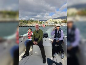 A joyful family enjoys a day out on the boat, capturing smiles and laughter against a scenic backdrop. Perfect for family outings and adventures on the water.