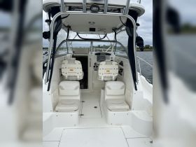 Interior view of a boat's helm and seating area, showcasing a clean and functional design ideal for navigation and comfort.