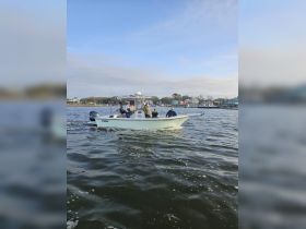 A group of friends enjoys a fishing trip on a boat, showcasing the excitement of on-water activities and camaraderie.