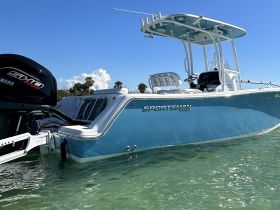 A striking view of a Sportsman boat gliding through clear waters, showcasing its sleek design and vibrant color — perfect for fishing or leisure outings.