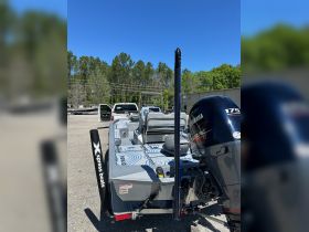 A detailed view of the rear of an Xpress boat, showcasing its sleek design and Yamaha motor, perfect for fishing and recreational outings.
