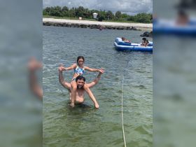 A joyful moment captured as a father and daughter enjoy a fun day in the water, showcasing the perfect family bonding experience at the beach.