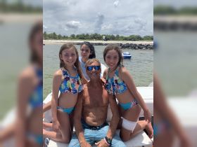 A joyful group of children and an adult pose together on a boat, capturing a fun moment on the water — perfect for family outings and summer adventures.