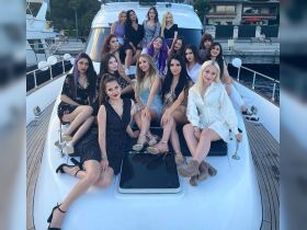 A lively group of friends poses on the deck of a luxurious yacht, capturing the essence of celebration and fun on the water.
