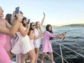 A lively group of friends celebrates on a boat, popping champagne and enjoying the moment — perfect for bachelorette parties or festive gatherings on the water.