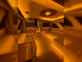 A cozy and well-lit interior of a boat cabin featuring comfortable seating and modern amenities, perfect for relaxing during a cruise.