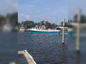 A lively group enjoys a fishing excursion aboard a charter boat, showcasing the excitement of on-water adventures.