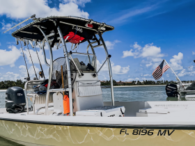 A detailed view of a center console boat equipped for fishing, showcasing its features against a beautiful sky — perfect for water adventures.