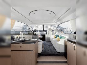 A beautifully designed interior of a luxury yacht featuring elegant seating and a modern helm, perfect for relaxing and enjoying the views while cruising.