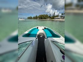 Interior view of a sleek boat showcasing comfortable seating, perfect for relaxing while enjoying the scenic turquoise waters.