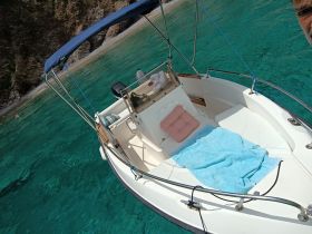 A cozy interior view of a boat featuring comfortable seating and a relaxing atmosphere, perfect for enjoying a day on the water.