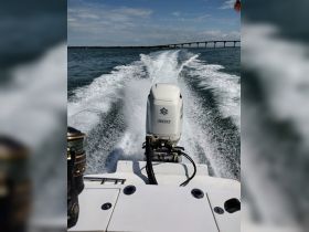 A dynamic view from the back of a speedboat, showcasing the powerful engine and the wake created as it speeds through the water, perfect for adventure seekers.