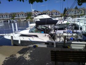 A fishing boat docked at a marina, showcasing its sleek design and fishing equipment, perfect for a day on the water.