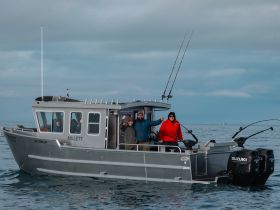 A group of friends enjoys a fishing trip on a sleek boat, showcasing camaraderie and adventure on the open water.