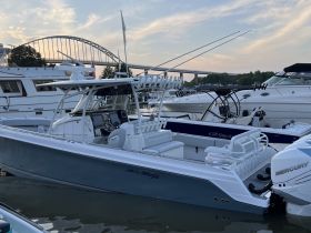 A sleek speedboat docked at the marina, showcasing its modern design and spacious seating — perfect for thrilling water adventures.