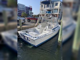 A sleek speedboat docked at the marina, showcasing its modern design and ready for a day on the water.