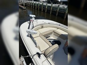 A close-up view of the interior seating and helm area of a boat, showcasing comfortable design and features ideal for a day on the water.