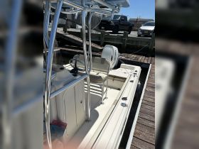 Interior view of a well-equipped boat featuring seating and a helm area, ideal for fishing or leisure outings.