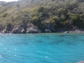 A stunning view of a rocky coastline surrounded by crystal-clear turquoise waters, perfect for exploring the natural beauty of the area.