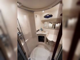 Interior view of a boat bathroom, showcasing modern amenities and a compact design, ideal for comfort while at sea.