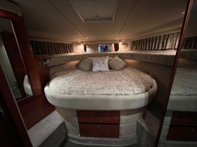 Cozy interior cabin of a boat featuring a spacious round bed and elegant decor, perfect for relaxation during your nautical adventures.