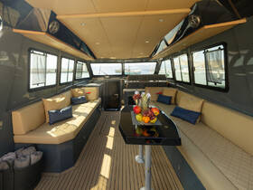 A stylish interior of a boat featuring comfortable seating and a dining area, perfect for relaxing and enjoying the views while on the water.