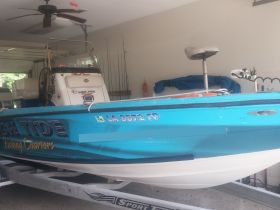 A well-equipped fishing charter boat interior showcasing the helm and seating area, perfect for a day on the water.