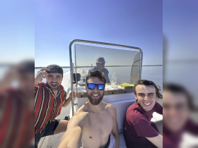 A group of friends enjoys a fun day on the water, capturing smiles and camaraderie aboard their boat.