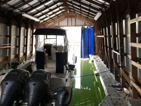 Interior view of a boat cabin showcasing the helm and seating area, perfect for a comfortable boating experience.