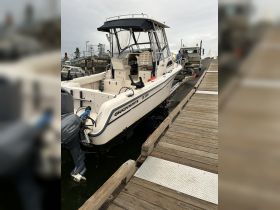 A Grady White center console boat docked at the marina, showcasing its sleek design and ready for a day on the water.