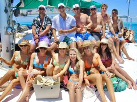 A lively group enjoys a fun day on a yacht, sipping drinks and soaking up the sun — perfect for summer celebrations and memorable outings on the water.