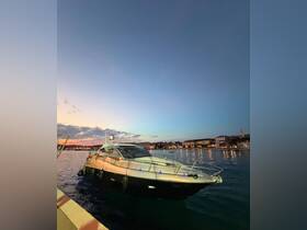 A sleek yacht docked at sunset, showcasing its elegant design against a picturesque waterfront backdrop.