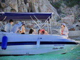 A lively group enjoys a day on the water in Cabo, capturing memories aboard their boat — perfect for celebrations and fun outings.