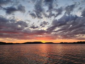 A breathtaking sunset over tranquil waters, showcasing vibrant colors and serene landscapes — perfect for capturing the beauty of nature.